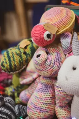 Hand-crocheted teddy bears and soft toys displayed by a local maker at Derryvolgie Twilight Market